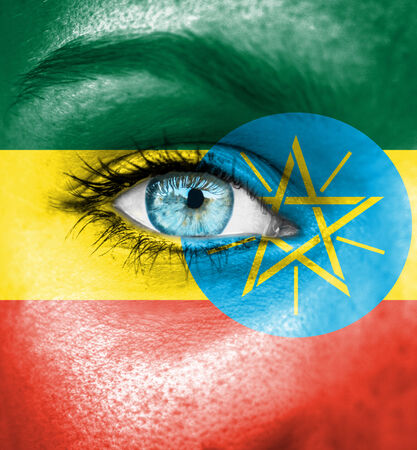 Woman face painted with flag of Ethiopiaの写真素材