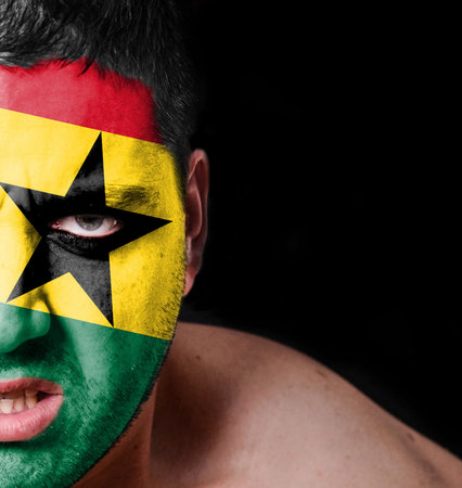 Portrait of angry man with painted flag of Ghanaの写真素材