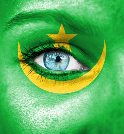 Woman face painted with flag of Mauritaniaの写真素材