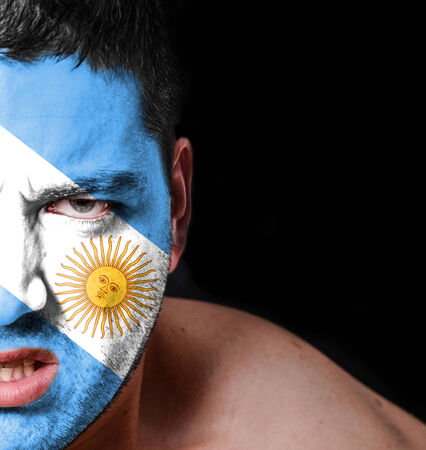 Portrait of angry man with painted flag of Argentinaの写真素材