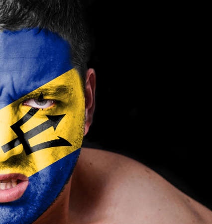 Portrait of angry man with painted flag of Barbadosの写真素材