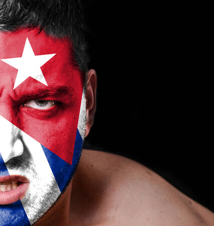 Portrait of angry man with painted flag of Cubaの写真素材