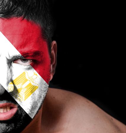 Portrait of angry man with painted flag of Egyptの写真素材