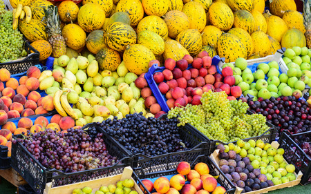 Market with various colorful fresh fruits and vegetablesの写真素材