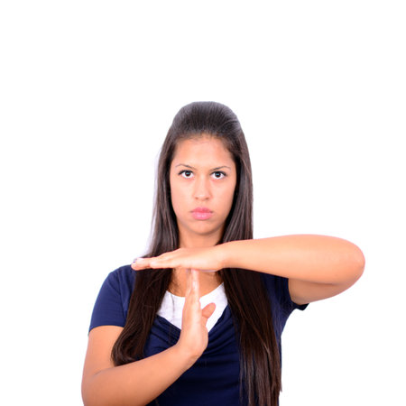 Young girl making time out gesture over white background