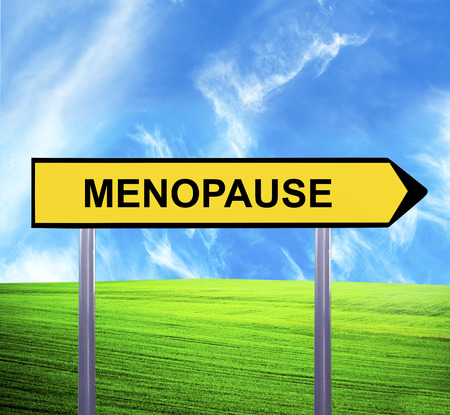 Conceptual arrow sign against beautiful landscape with text - MENOPAUSEの写真素材