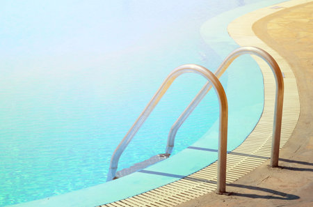 Swimming pool in curved shhape with stairs