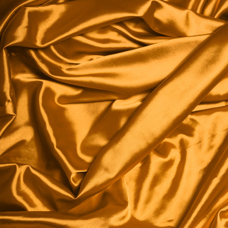Smooth elegant gold silk backgroundの写真素材