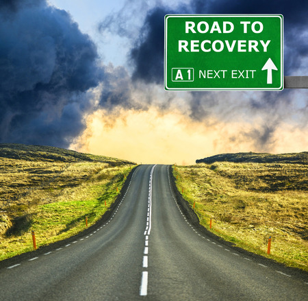 ROAD TO RECOVERY road sign against clear blue skyの写真素材