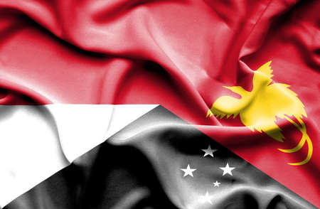 Waving flag of Papua New Guinea and Indonesiaの写真素材