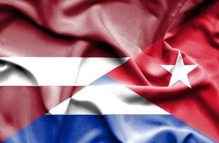 Waving flag of Cuba and Latviaの写真素材