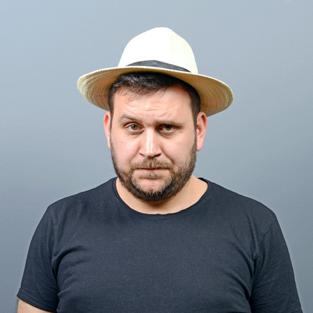 Portrait of funny chubby man wearing straw hatの写真素材