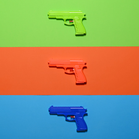 Toy pistols on colorful background  - Minimal design top viewの写真素材