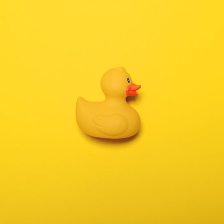 Yellow rubber duck on yellow background - Minimal designの写真素材