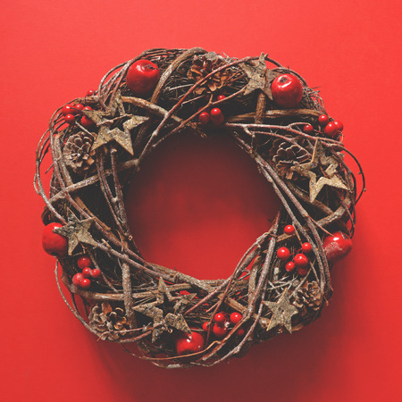 Flat lay of Christmas wreath on red background - Trendy minimal flat lay designの写真素材