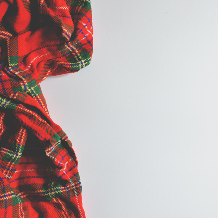 Flat lay of scarf with Christmas tartan texture on white background - Trendy minimal flat lay designの写真素材