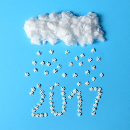 2017 loading with snowflakes falling from cotton clouds - Unique minimal flat lay designの写真素材