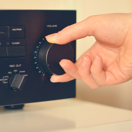 Hand turning volume up - Hi fidelity soudn conceptの写真素材