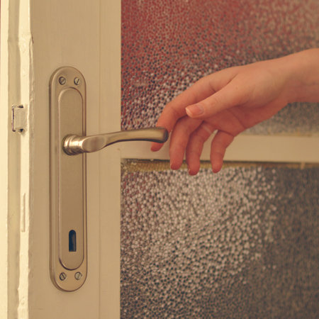 Woman hands closing r opening doorの写真素材