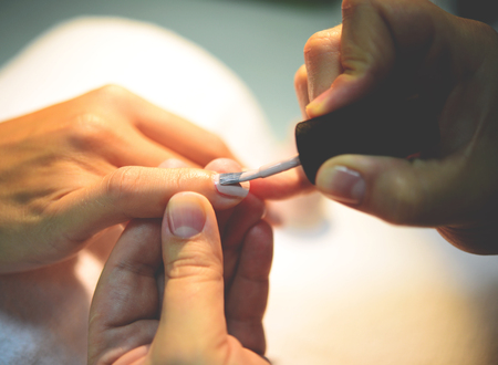 Close up of process of manicure at beauty salonの写真素材