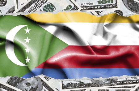 Financial concept with banknotes of US currency around national flag of Comorosの写真素材
