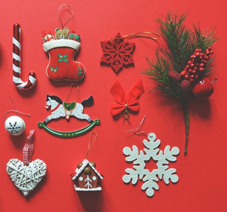 Flat lay of Christmas decoration and ornaments on red background - Trendy minimal flat lay design