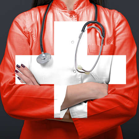 Doctor representing healthcare system with National flag of Switzerlandの写真素材