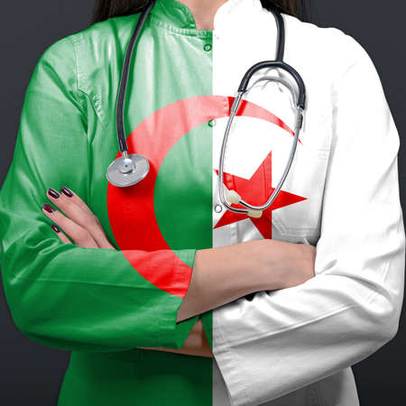 Doctor representing healthcare system with National flag of Algeriaの写真素材