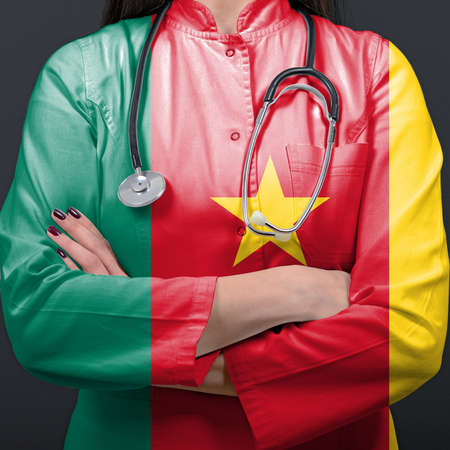 Doctor representing healthcare system with National flag of Cameroonの写真素材