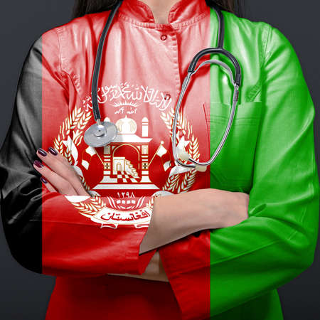 Doctor representing healthcare system with National flag of Afghanistanの写真素材