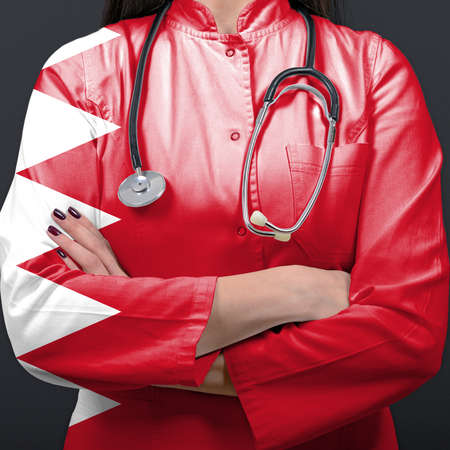 Doctor representing healthcare system with National flag of Bahrainの写真素材