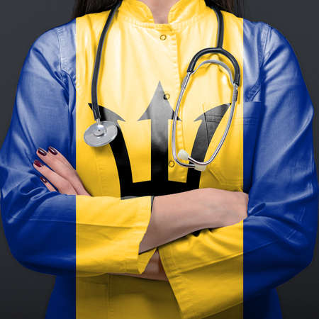 Doctor representing healthcare system with National flag of Barbadosの写真素材