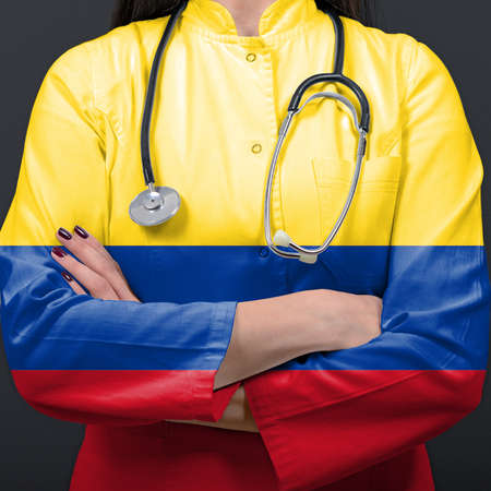 Doctor representing healthcare system with National flag of Columbiaの写真素材