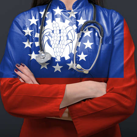 Doctor representing healthcare system with National flag of Myanmarの写真素材