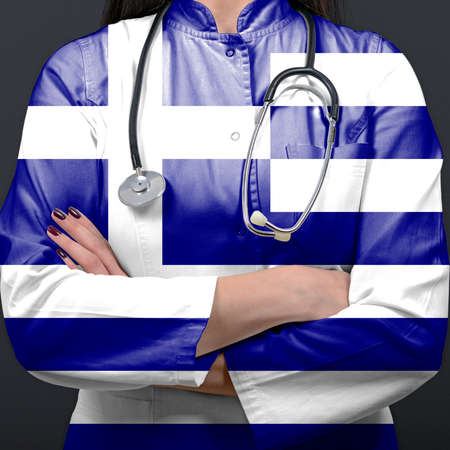 Doctor representing healthcare system with National flag of Greeceの写真素材