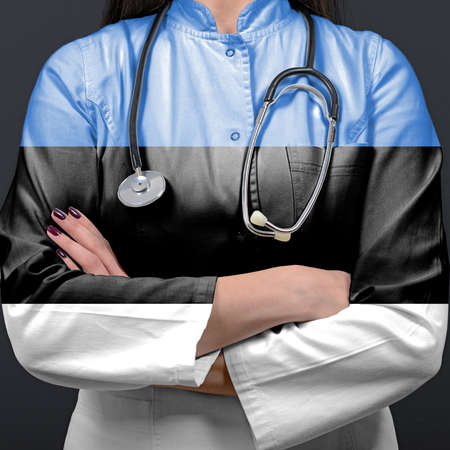 Doctor representing healthcare system with National flag of Estoniaの写真素材