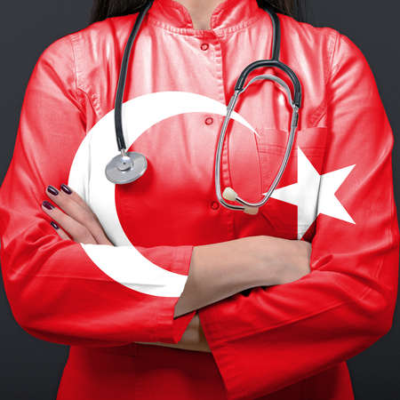Doctor representing healthcare system with National flag of Turkeyの写真素材