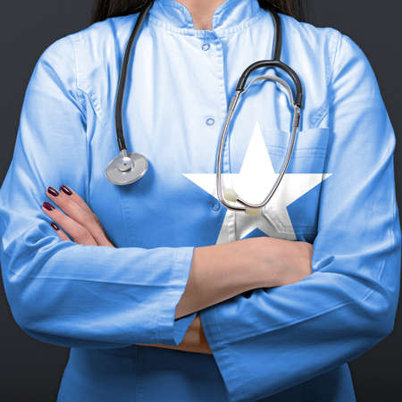 Doctor representing healthcare system with National flag of Somaliaの写真素材