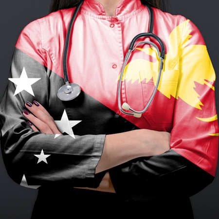 Doctor representing healthcare system with National flag of Papua New Guineaの写真素材