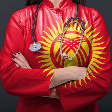 Doctor representing healthcare system with National flag of Kyrgyzstanの写真素材