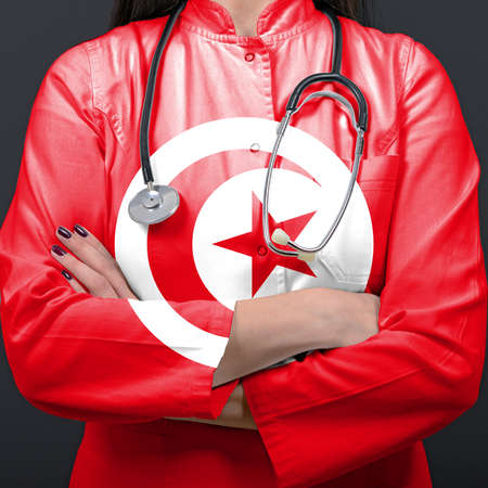 Doctor representing healthcare system with National flag of Tunisiaの写真素材