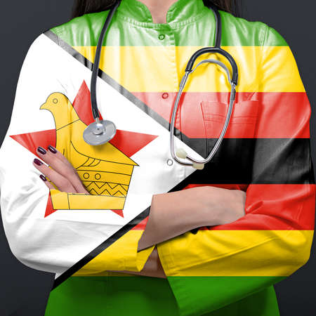 Doctor representing healthcare system with National flag of Zimbabweの写真素材