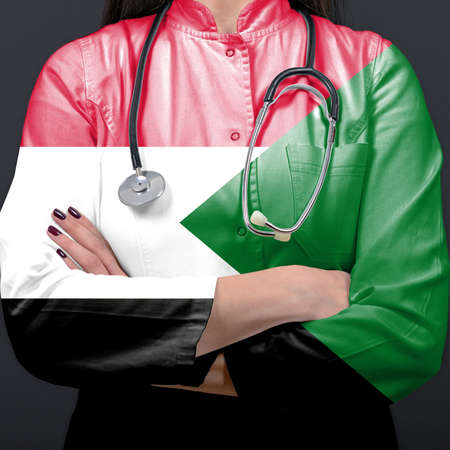 Doctor representing healthcare system with National flag of Sudanの写真素材