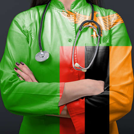 Doctor representing healthcare system with National flag of Zambiaの写真素材