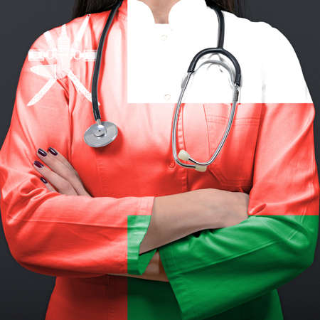 Doctor representing healthcare system with National flag of Omanの写真素材