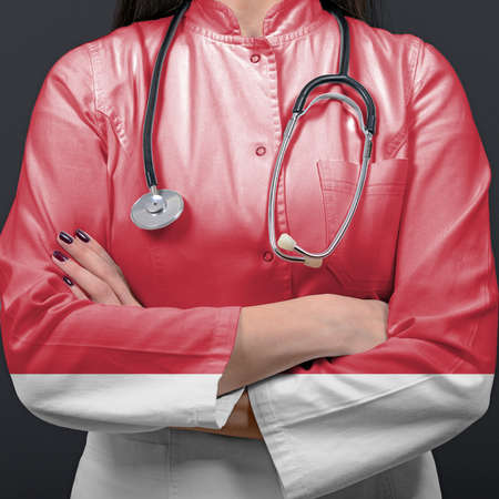 Doctor representing healthcare system with National flag of Indonesiaの写真素材