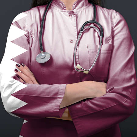 Doctor representing healthcare system with National flag of Qatarの写真素材
