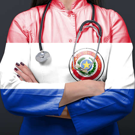 Doctor representing healthcare system with National flag of Paraguayの写真素材