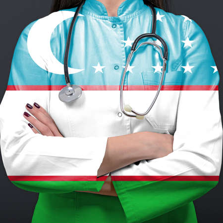 Doctor representing healthcare system with National flag of Uzbekistanの写真素材
