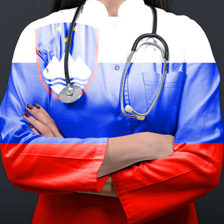 Doctor representing healthcare system with National flag of Sloveniaの写真素材